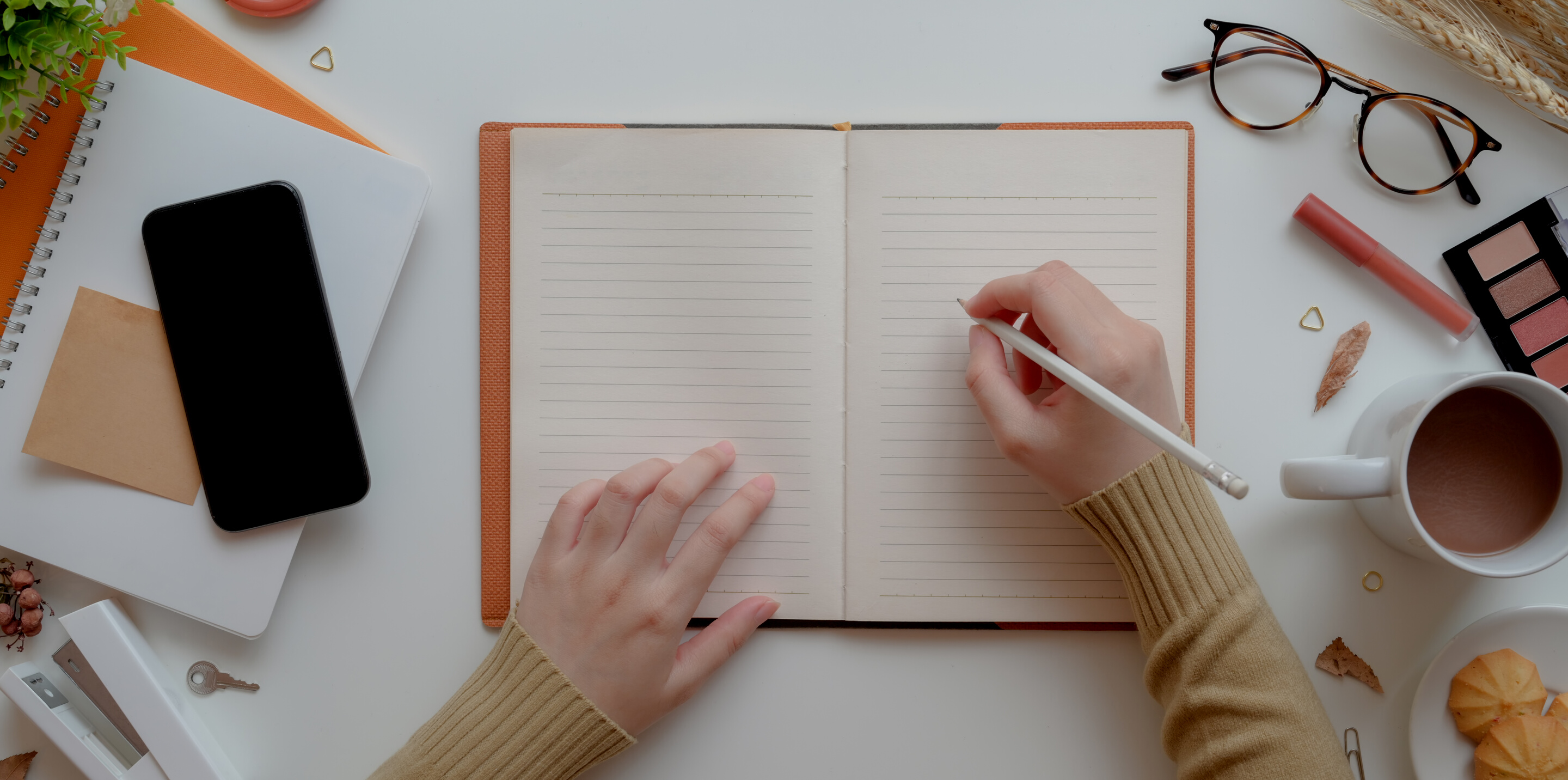 Photo Of Person Writing On Notebook